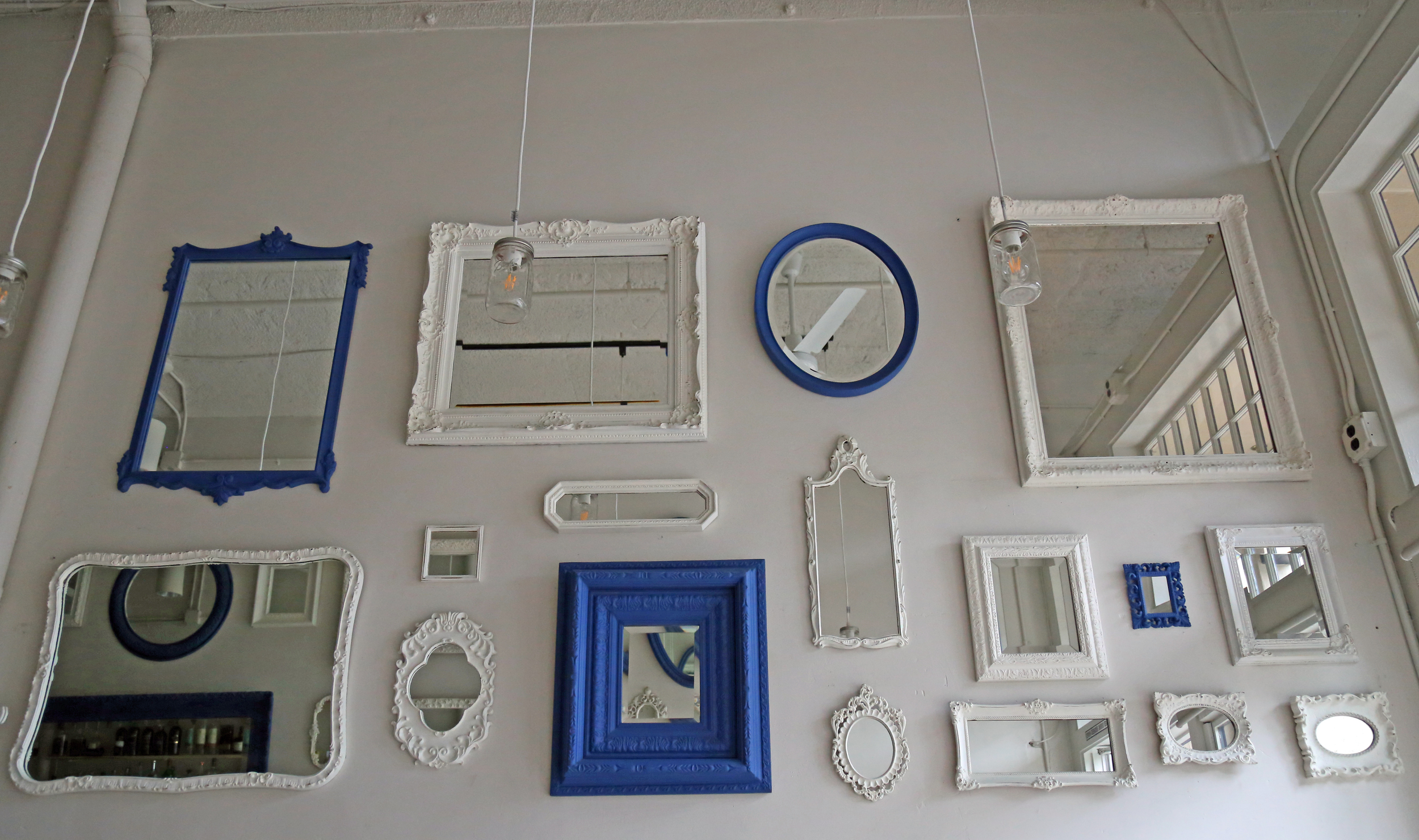 Painted mirrors decorate the white walls.