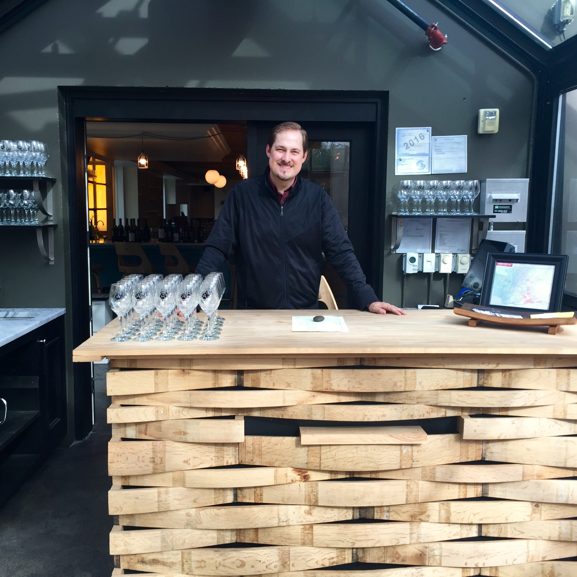 Ben Almquist showcasing the bar in the lovely greenhouse at 198 Nickerson St.